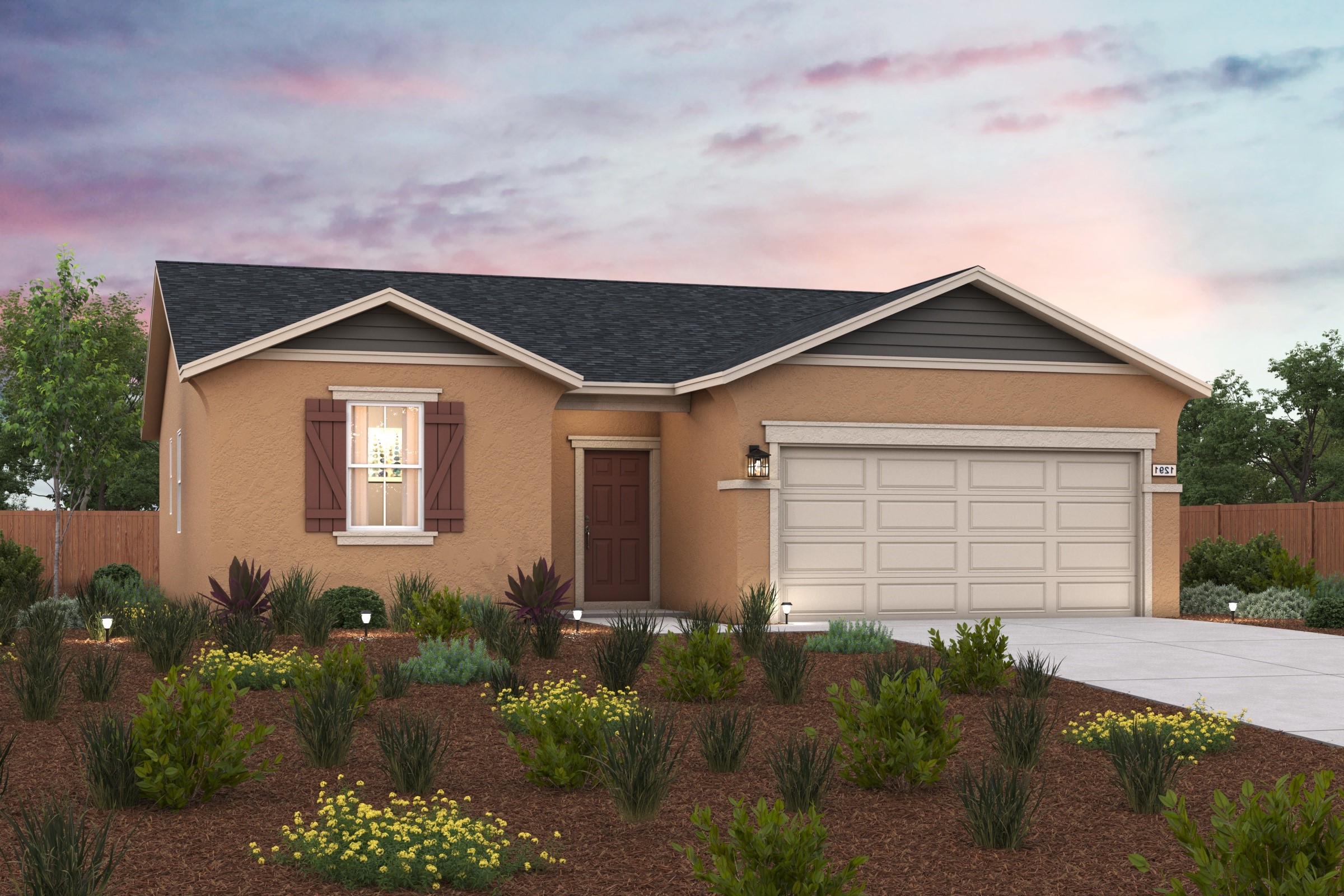 A house with a garage and plants in the front.