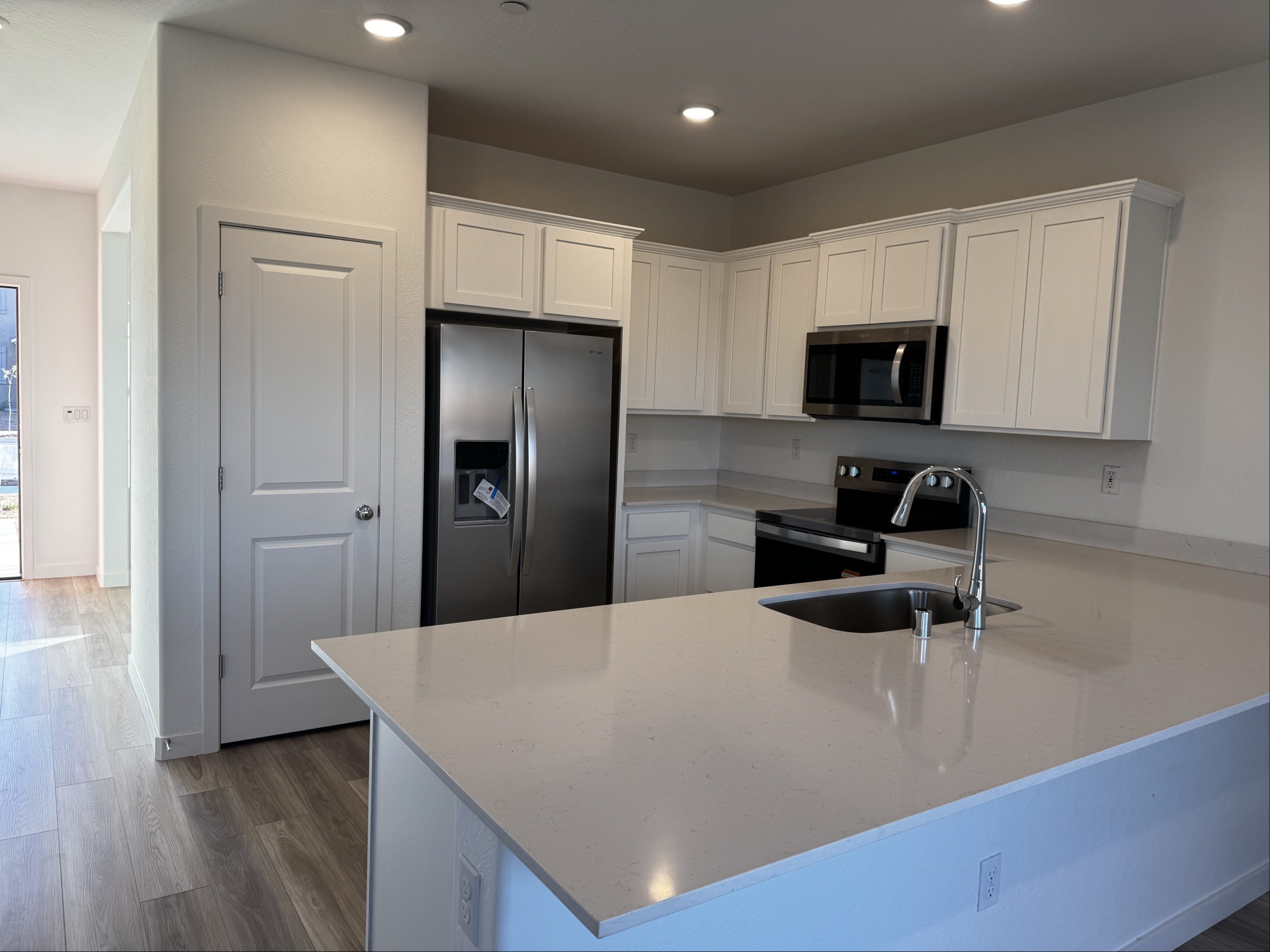 A kitchen with white cabinets.