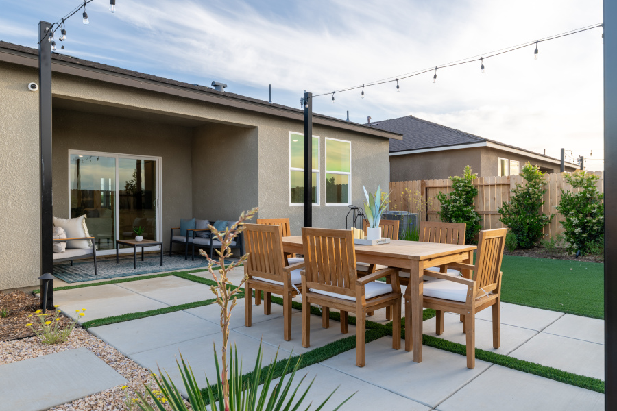 A patio with a table and chairs.