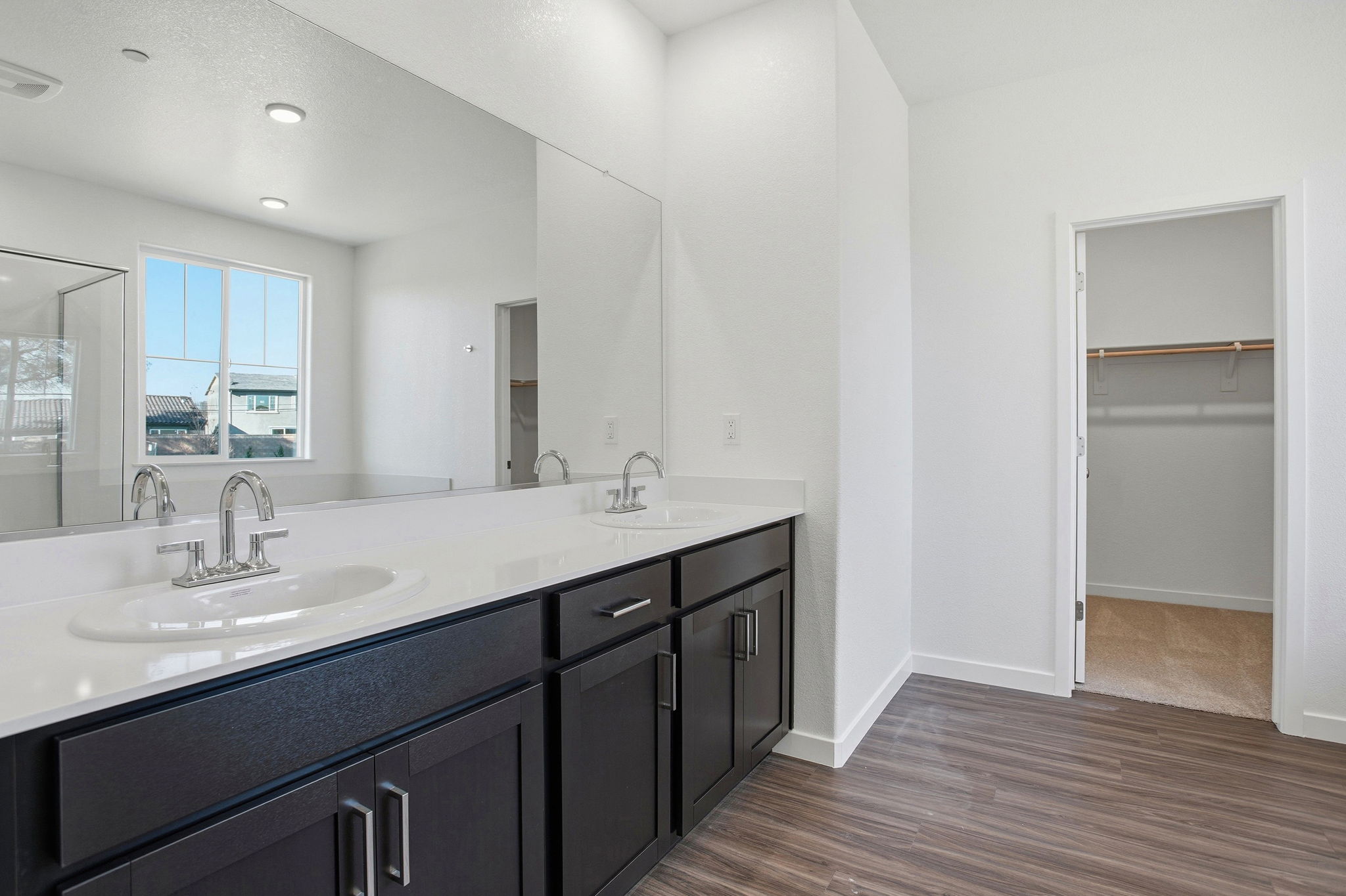 A bathroom with a large mirror.