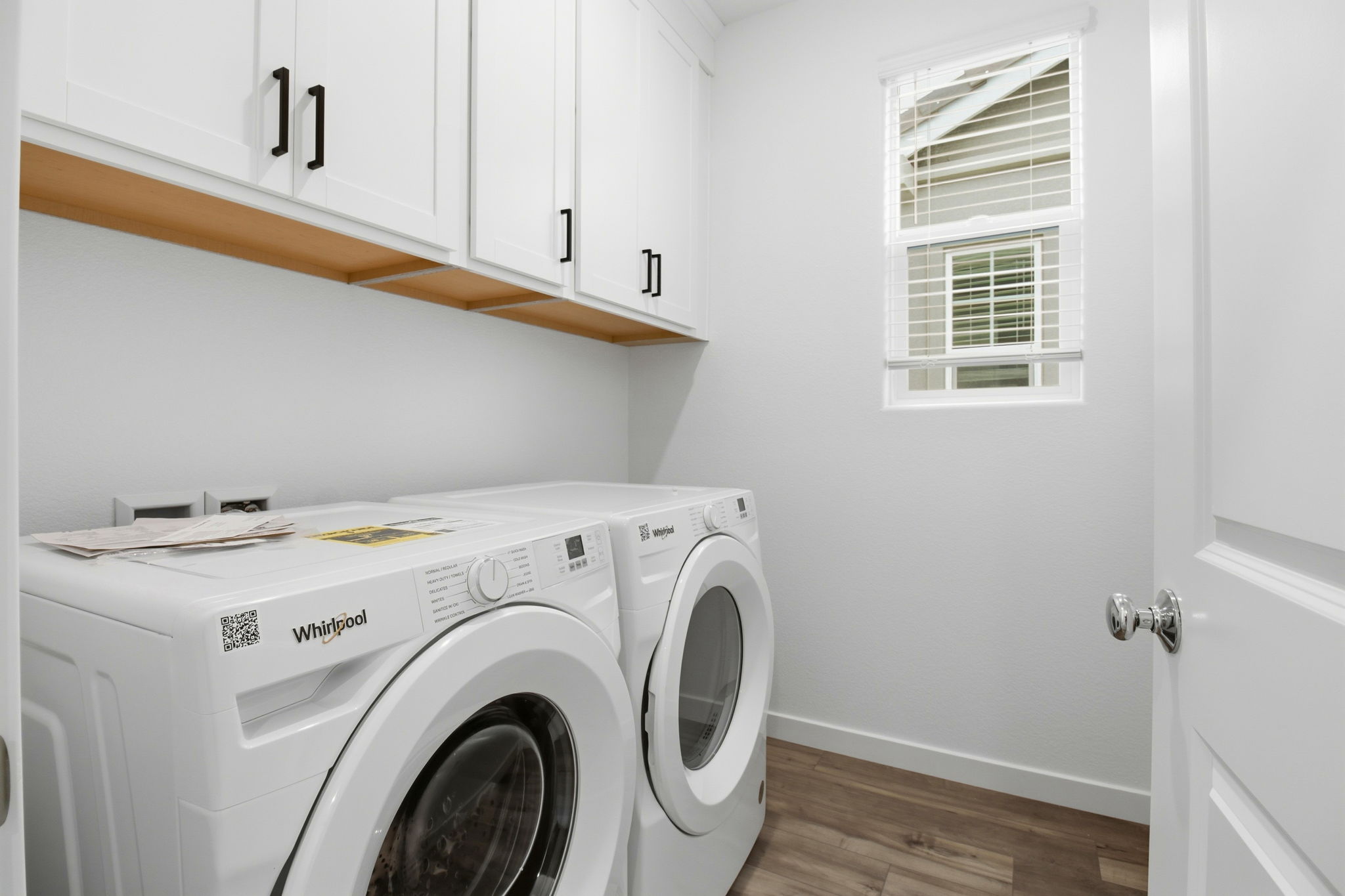 A washing machine in a room.