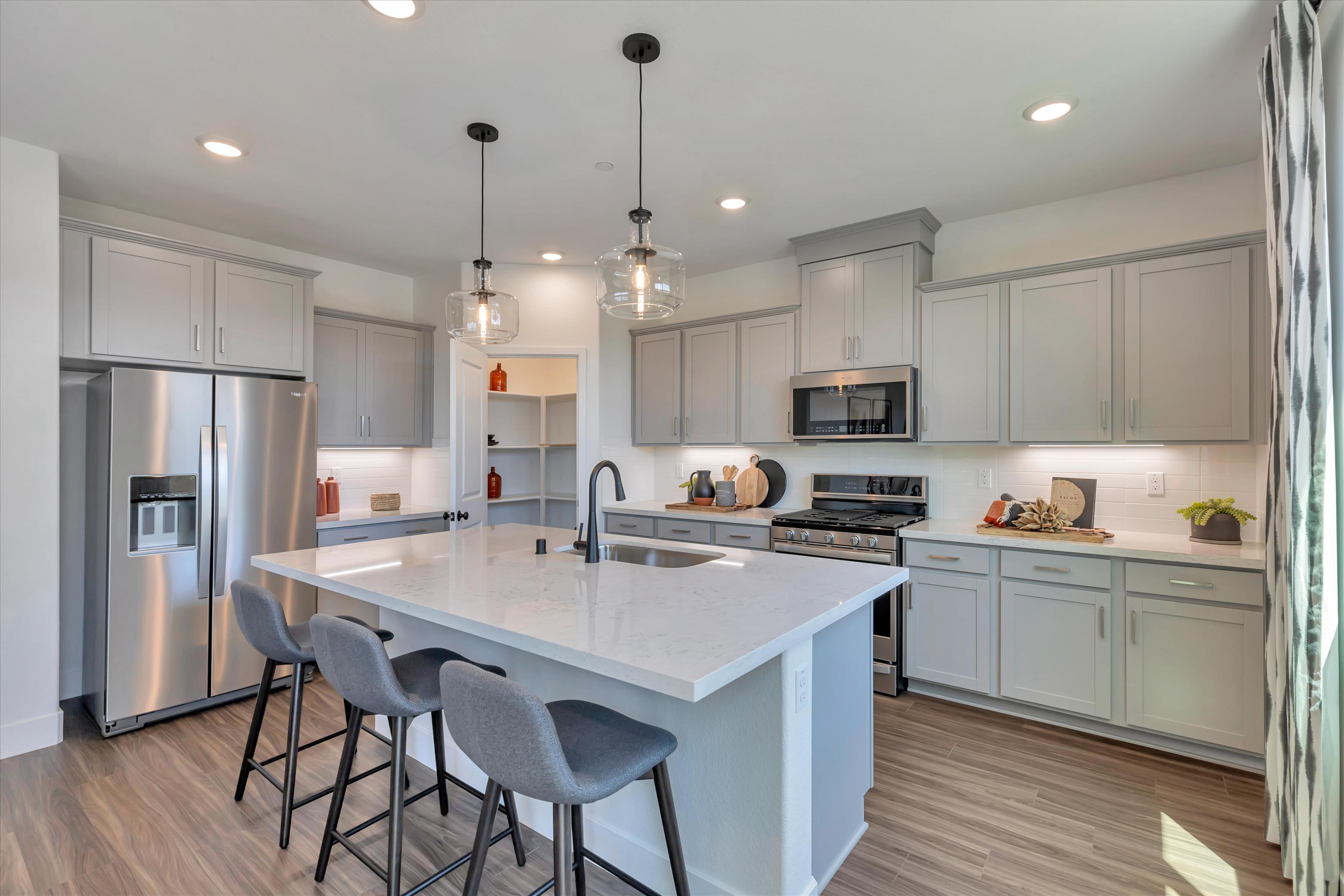 A kitchen with white cabinets.