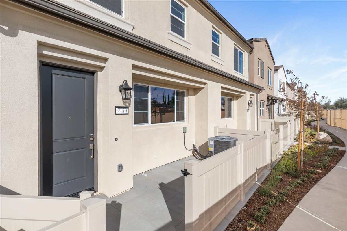 A white building with a black door.