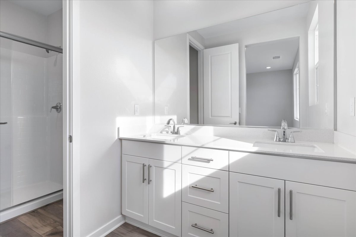 A bathroom with white cabinets.