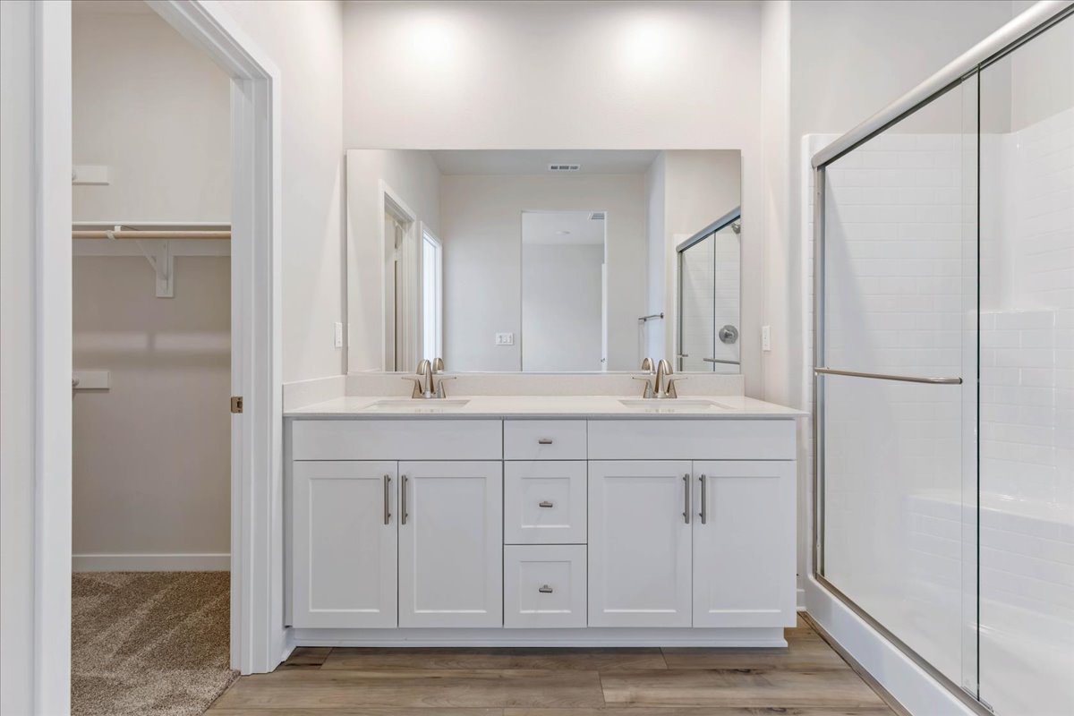 A bathroom with white cabinets.