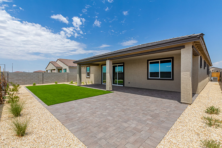A house with a stone driveway.