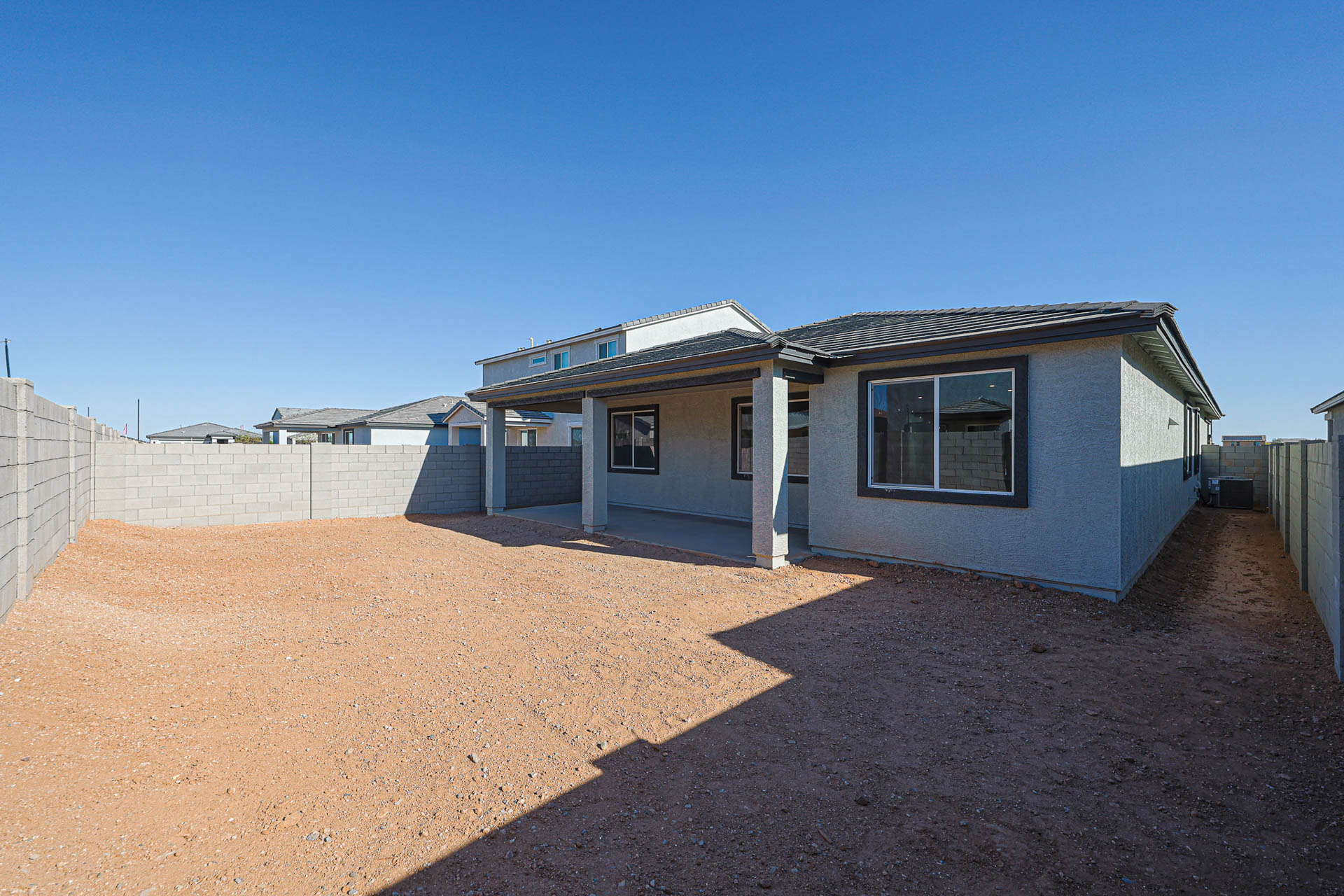 A house with a dirt yard.
