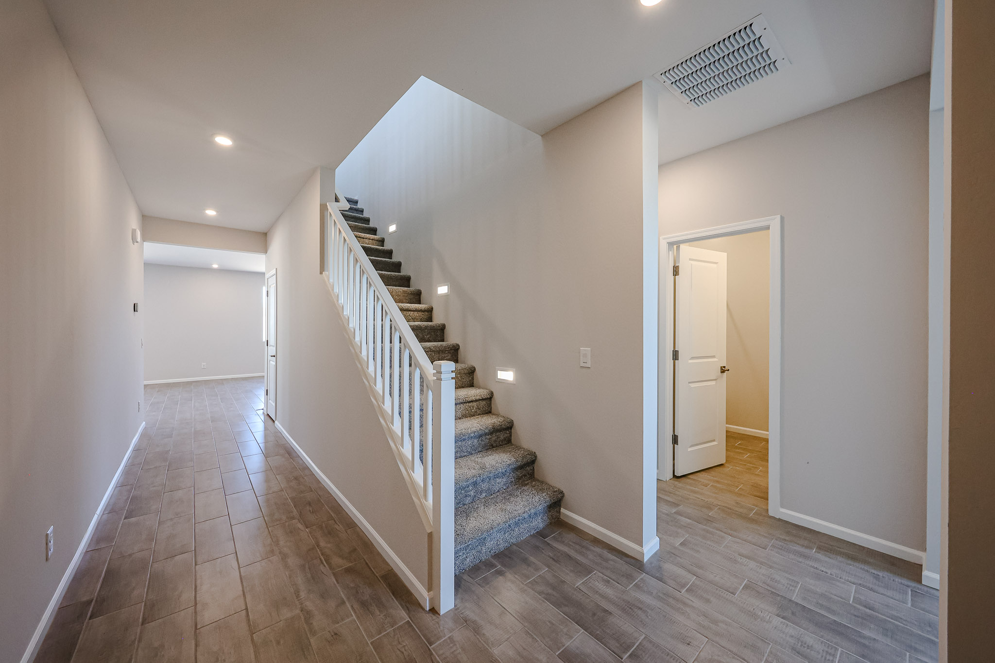 A hallway with a wood floor.