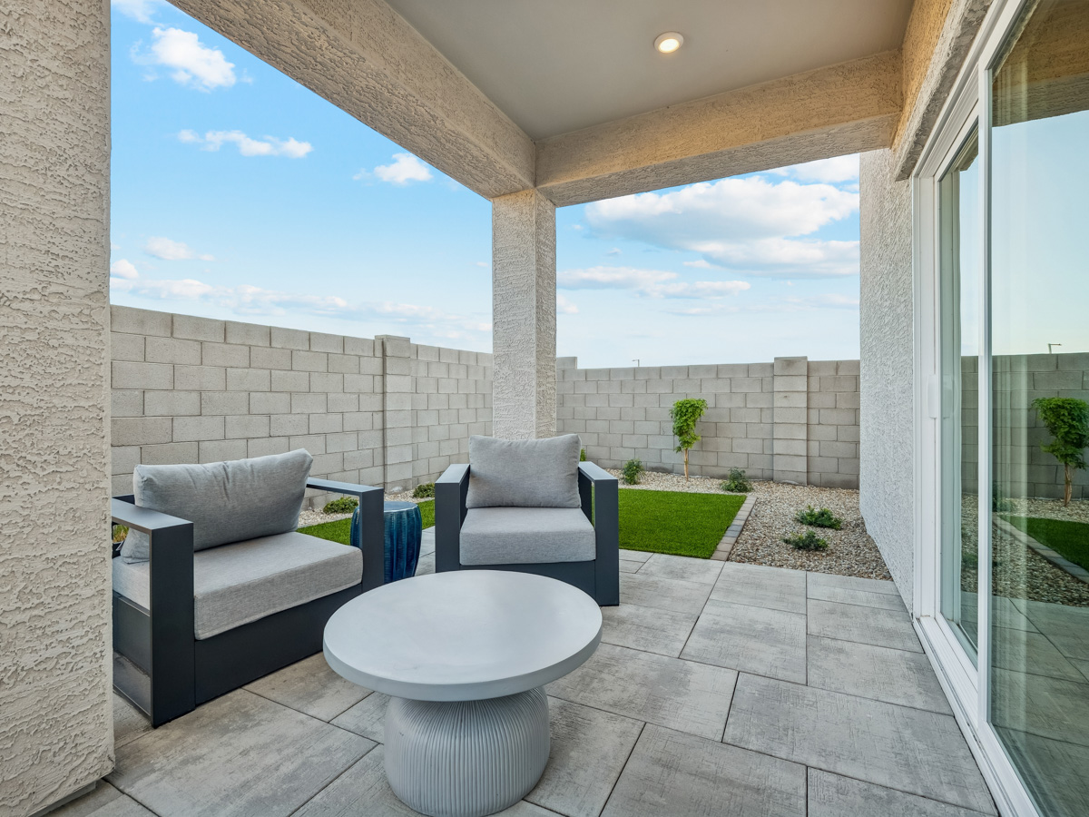 A patio with a table and chairs.