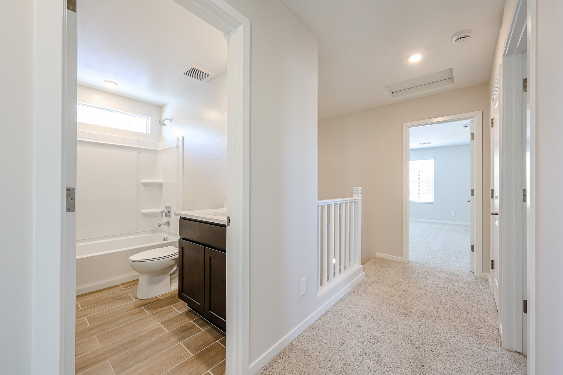 A bathroom with a toilet and bathtub.