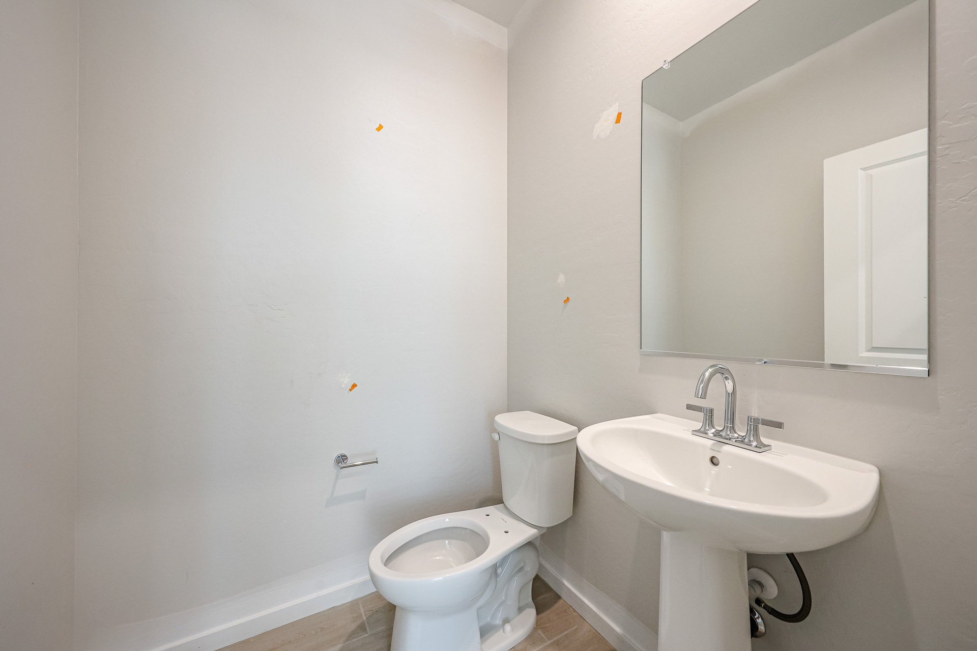 A bathroom with a toilet and sink.