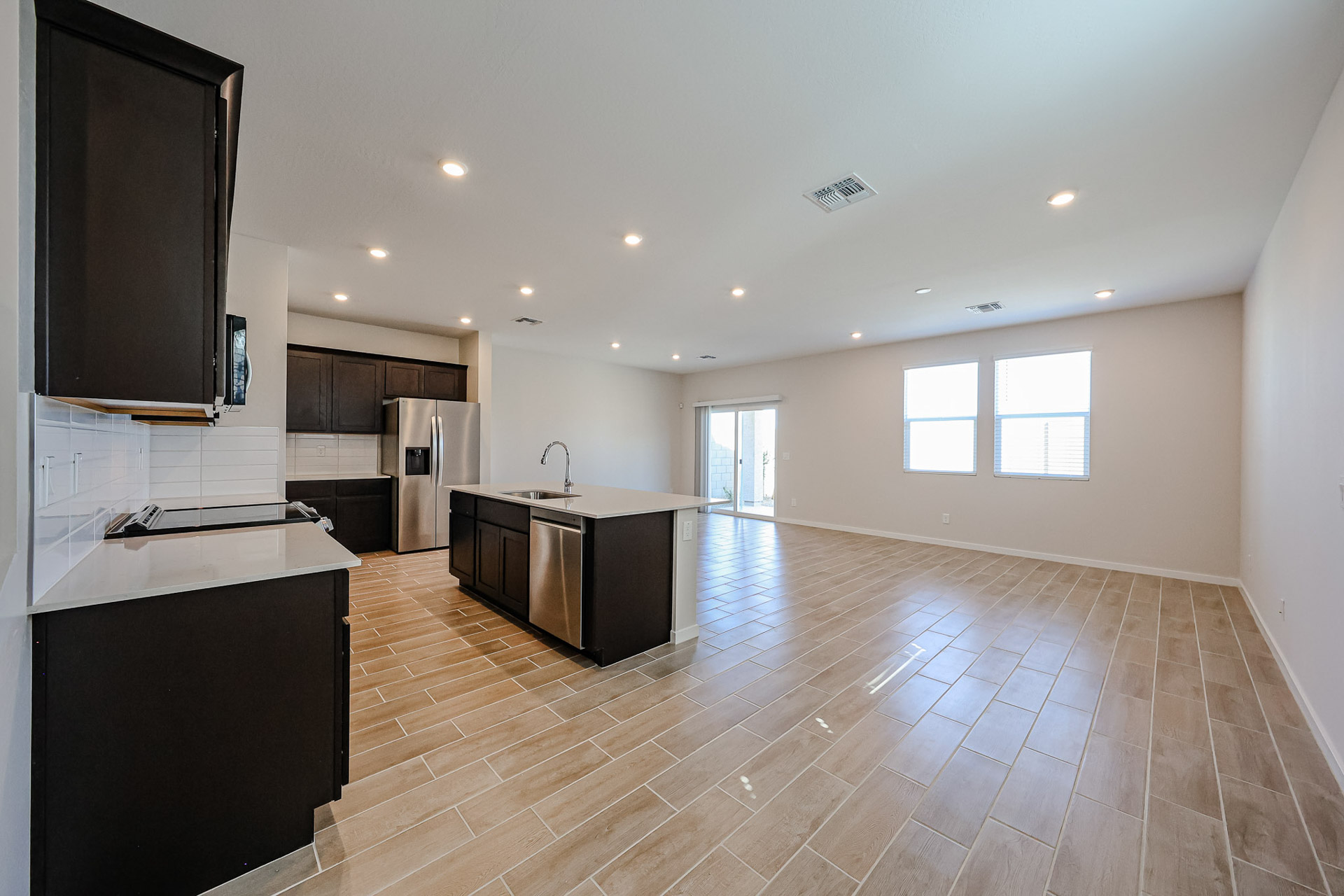 A large kitchen with a wood floor.