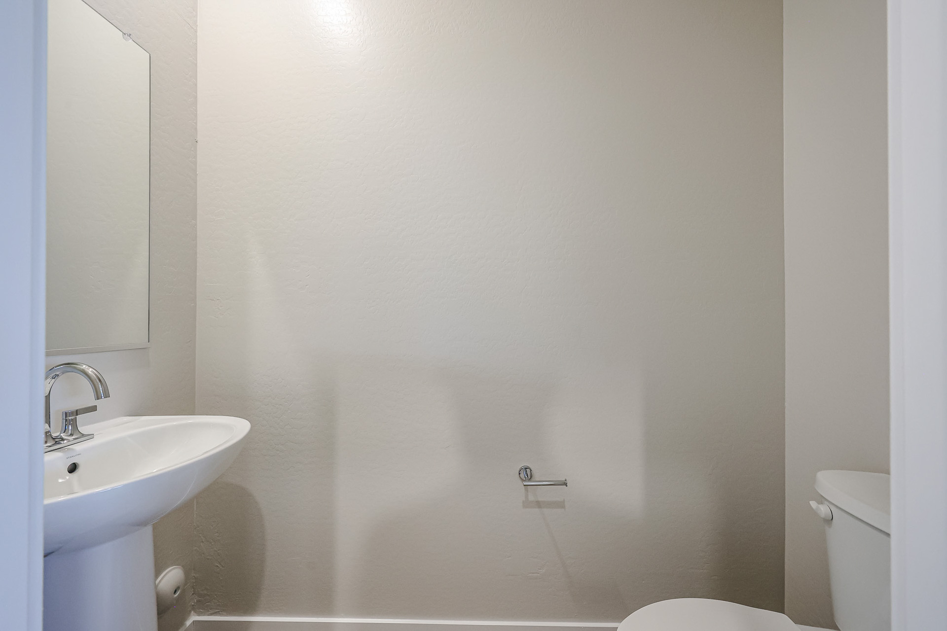 A bathroom with a sink and toilet.