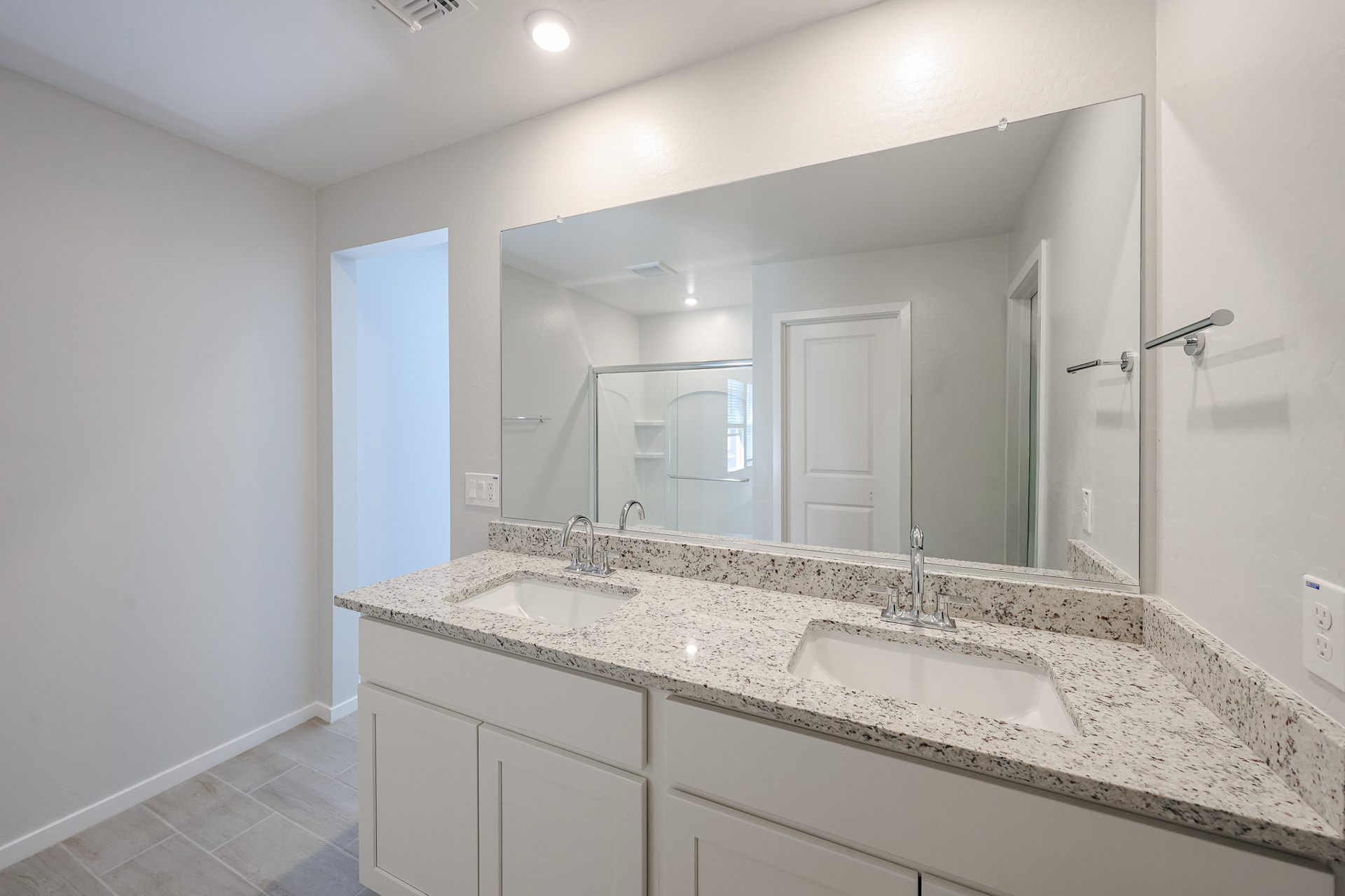 A bathroom with a large mirror.