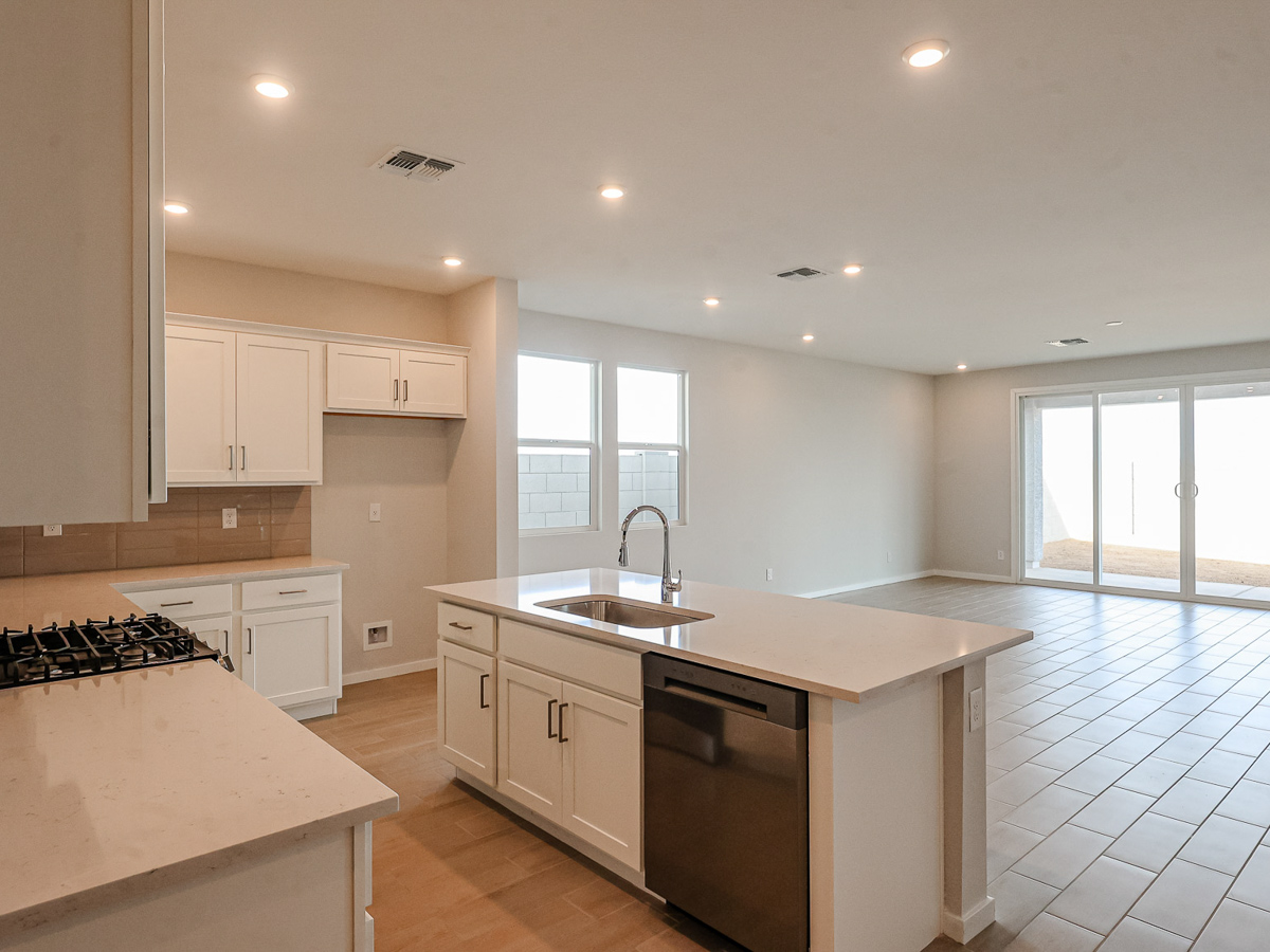A kitchen with white cabinets.