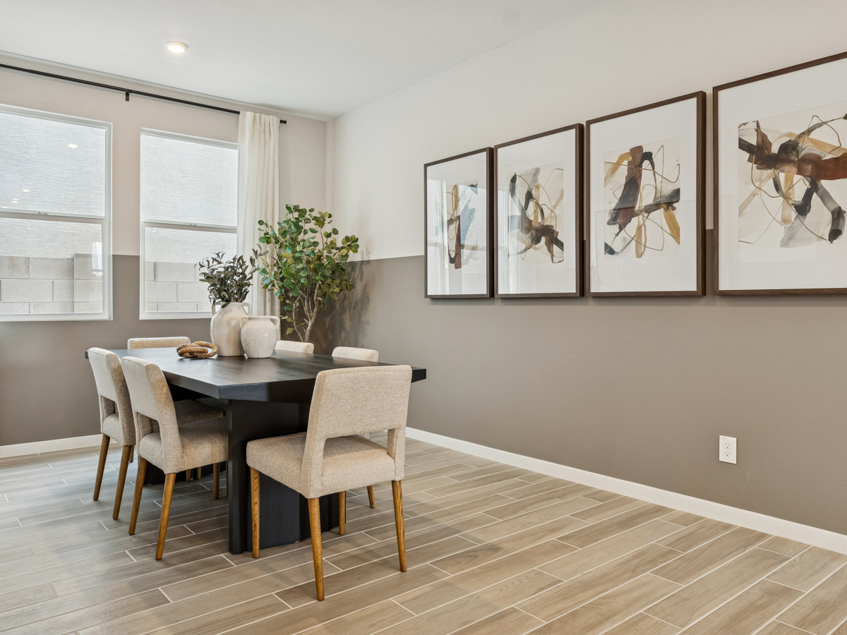 A dining room with a table and chairs.