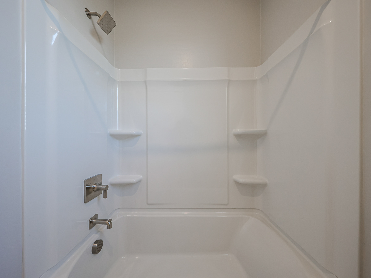 A bathroom with a bathtub and toilet.