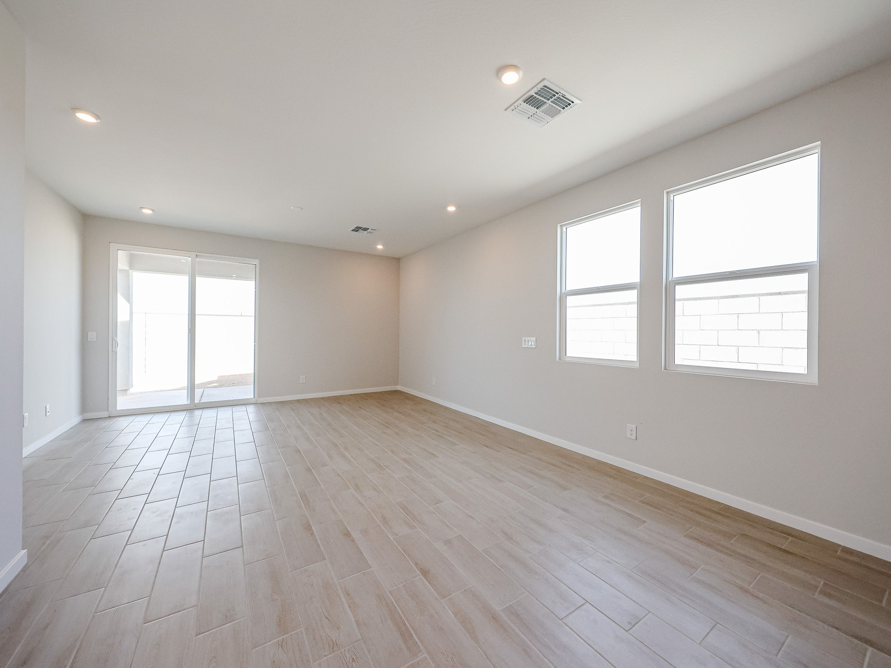 A room with windows and wood floors.