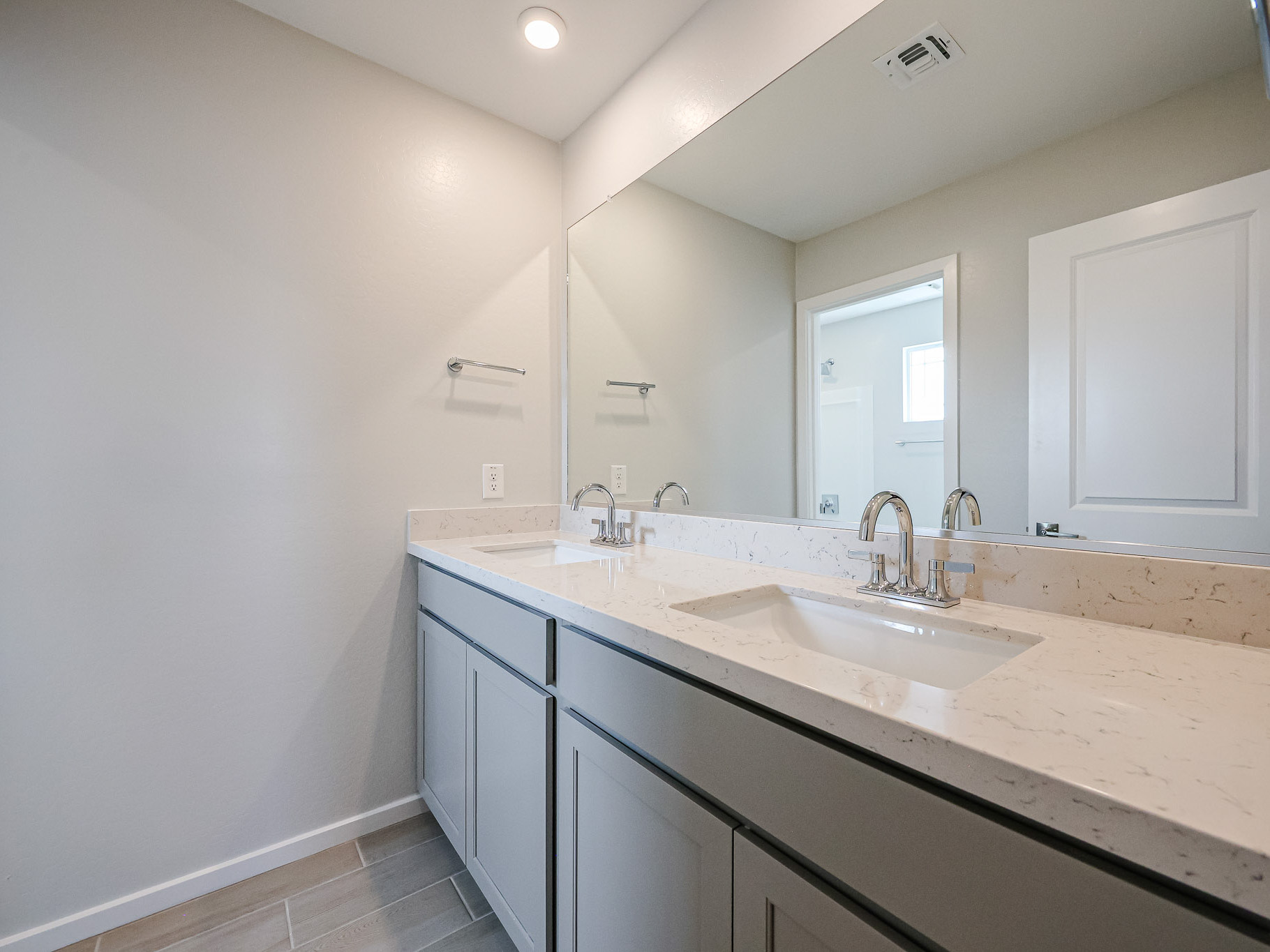 A bathroom with a large mirror.