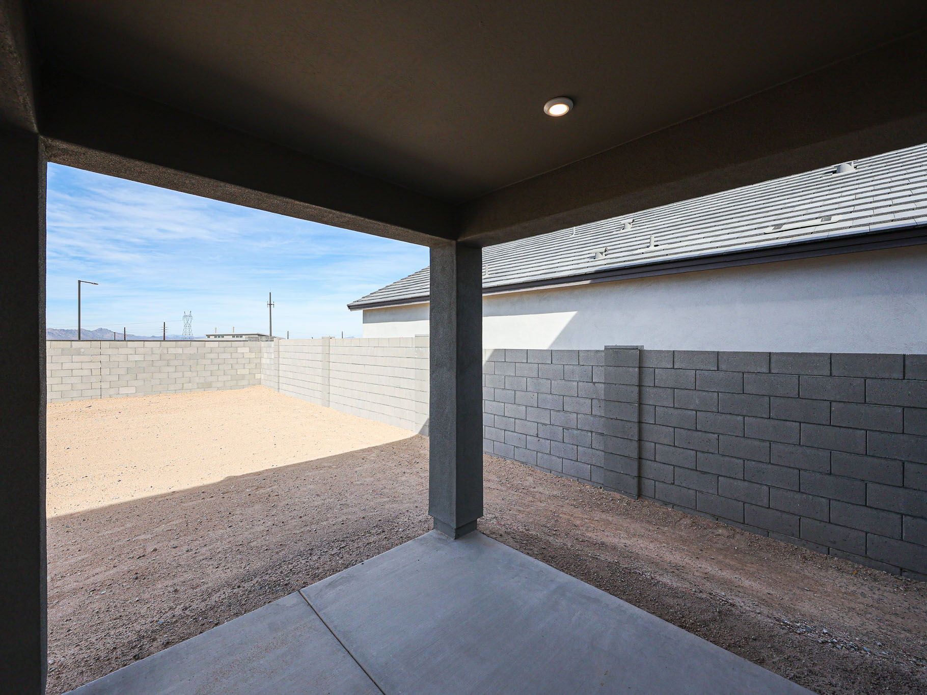 A concrete wall with a brick walkway.