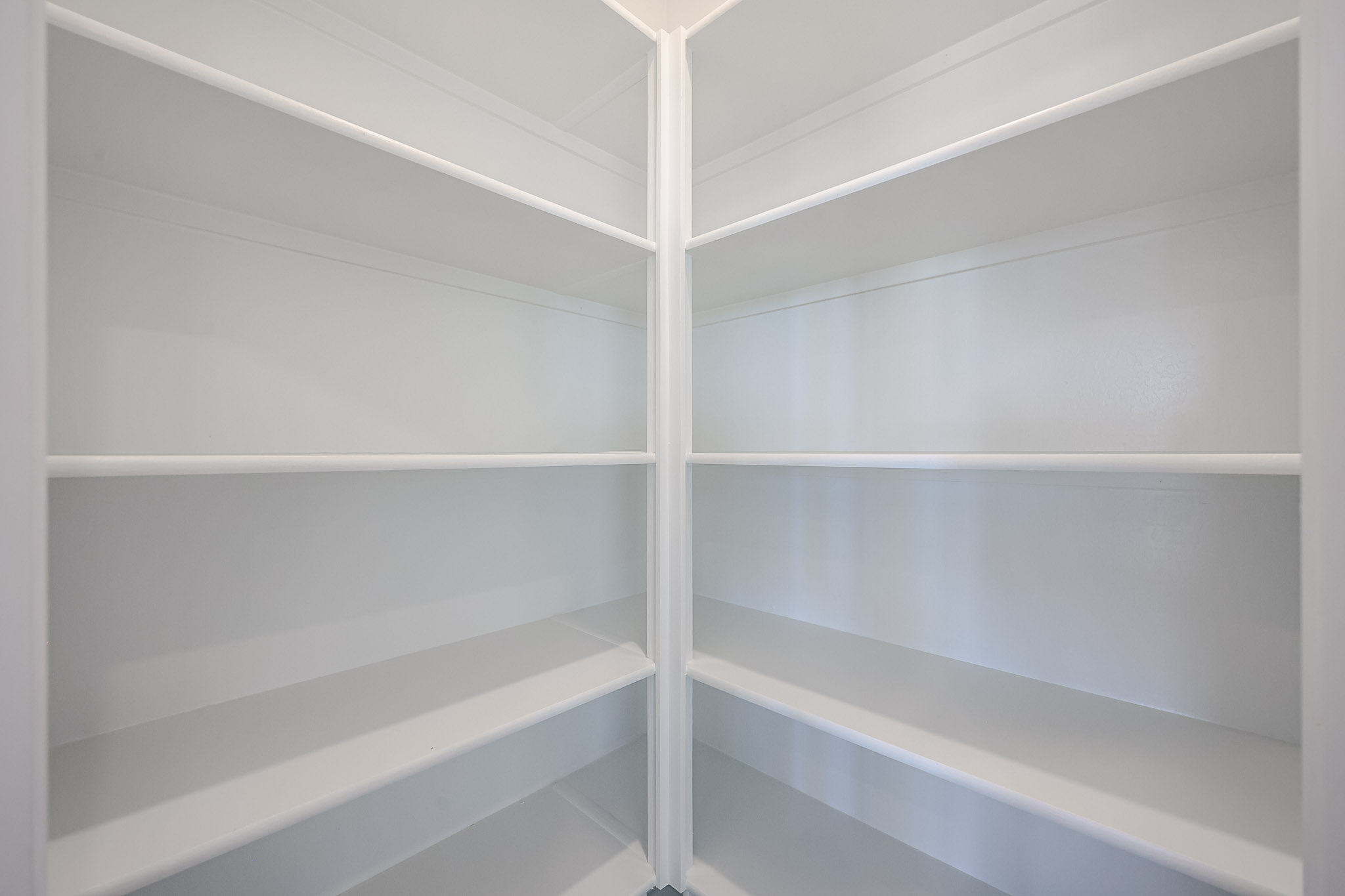 A white wall with a white railing.