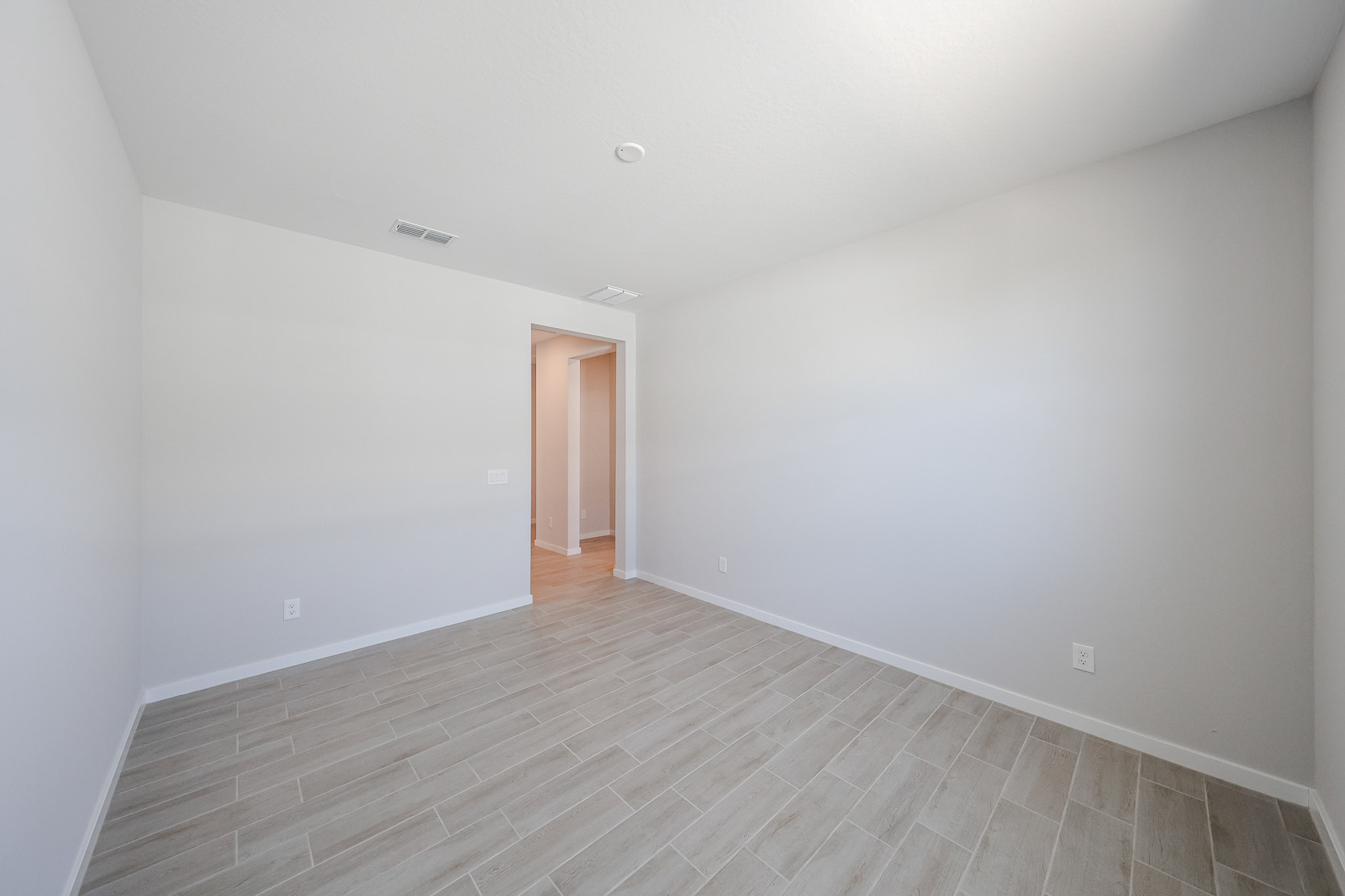A room with a wood floor and a wood floor.