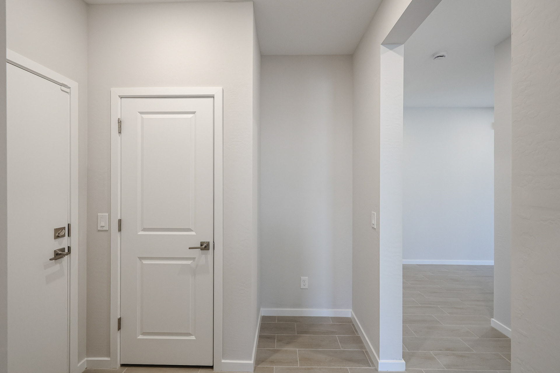 A hallway with white doors.