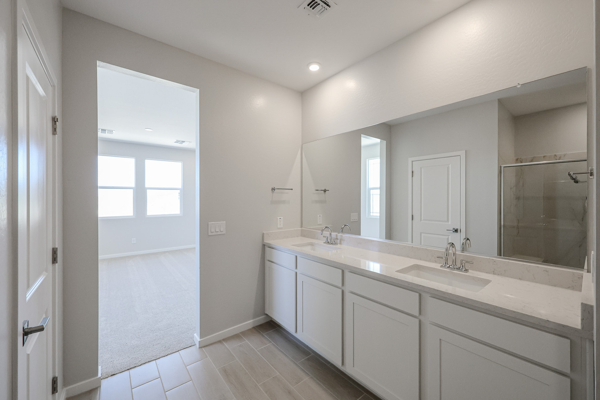 A bathroom with a large mirror.