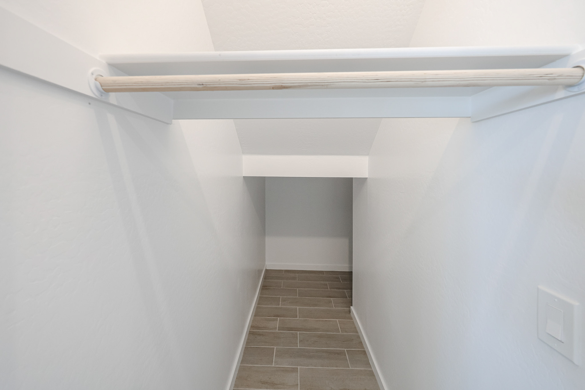 A white shelf with a white wall.