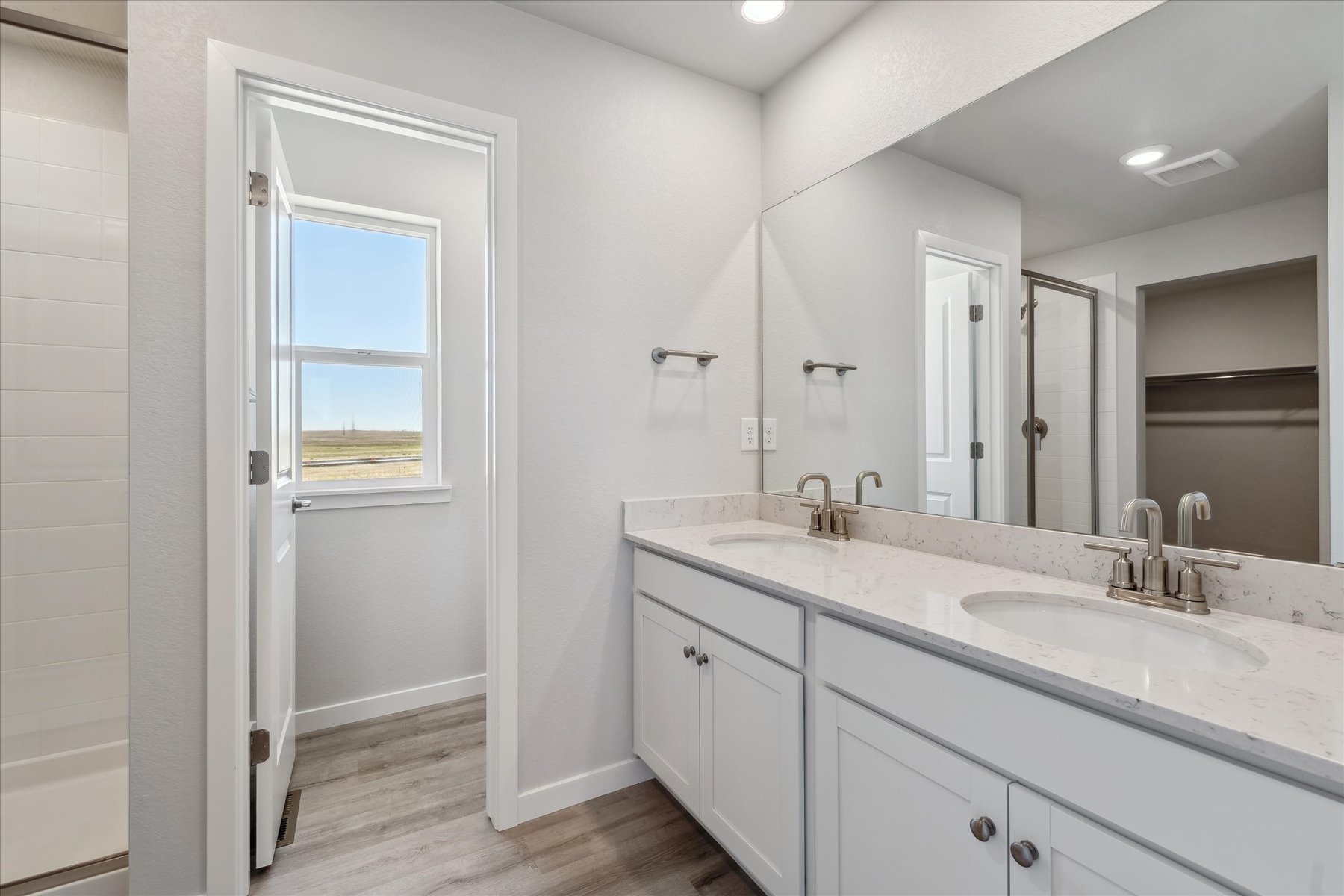 A bathroom with a large mirror.