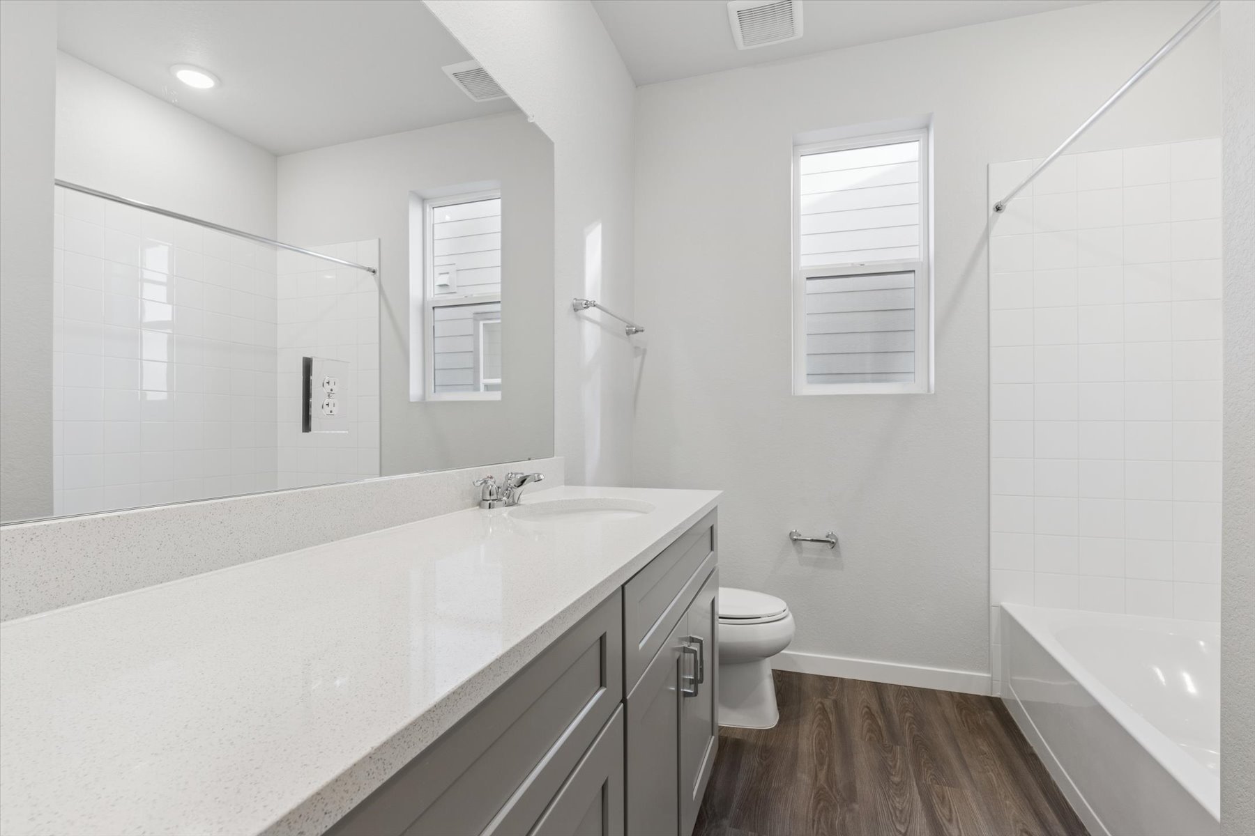 A bathroom with a tub toilet and sink.