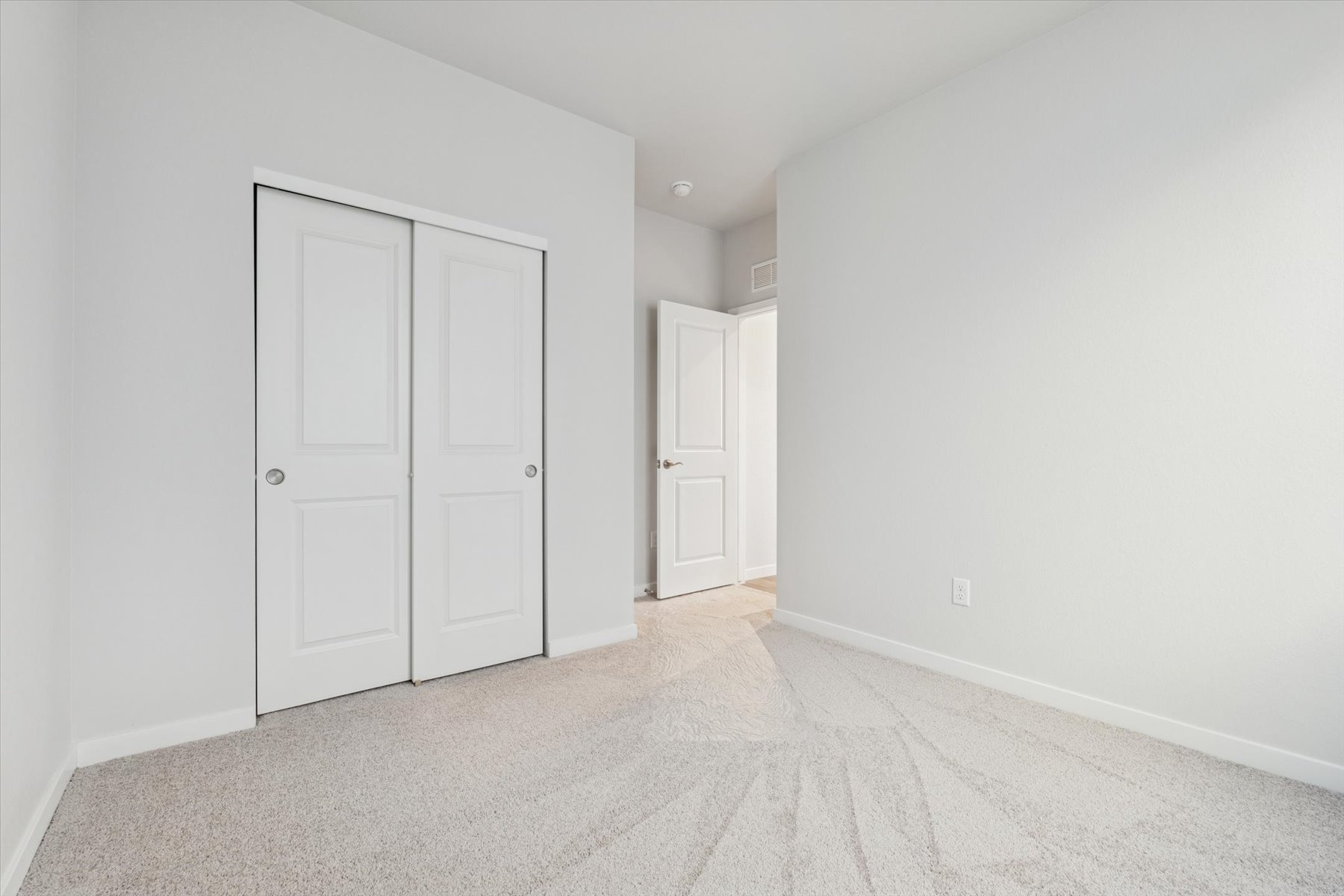 A hallway with white doors.