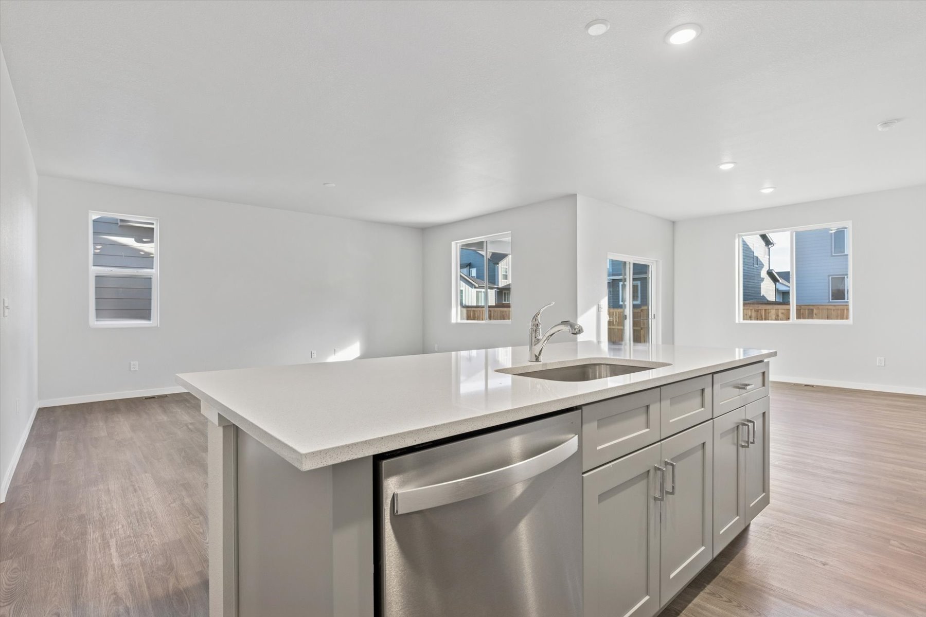 A kitchen with white cabinets.
