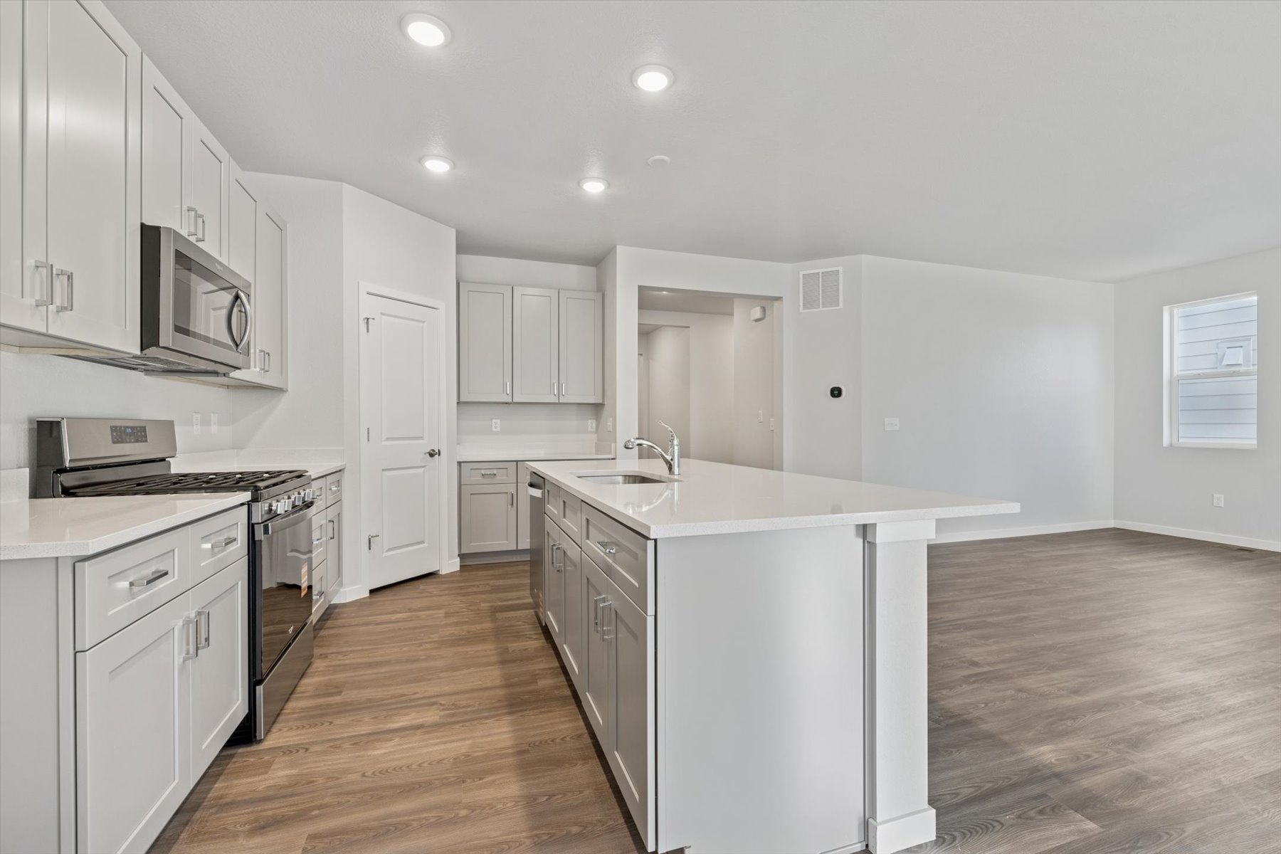 A kitchen with white cabinets.