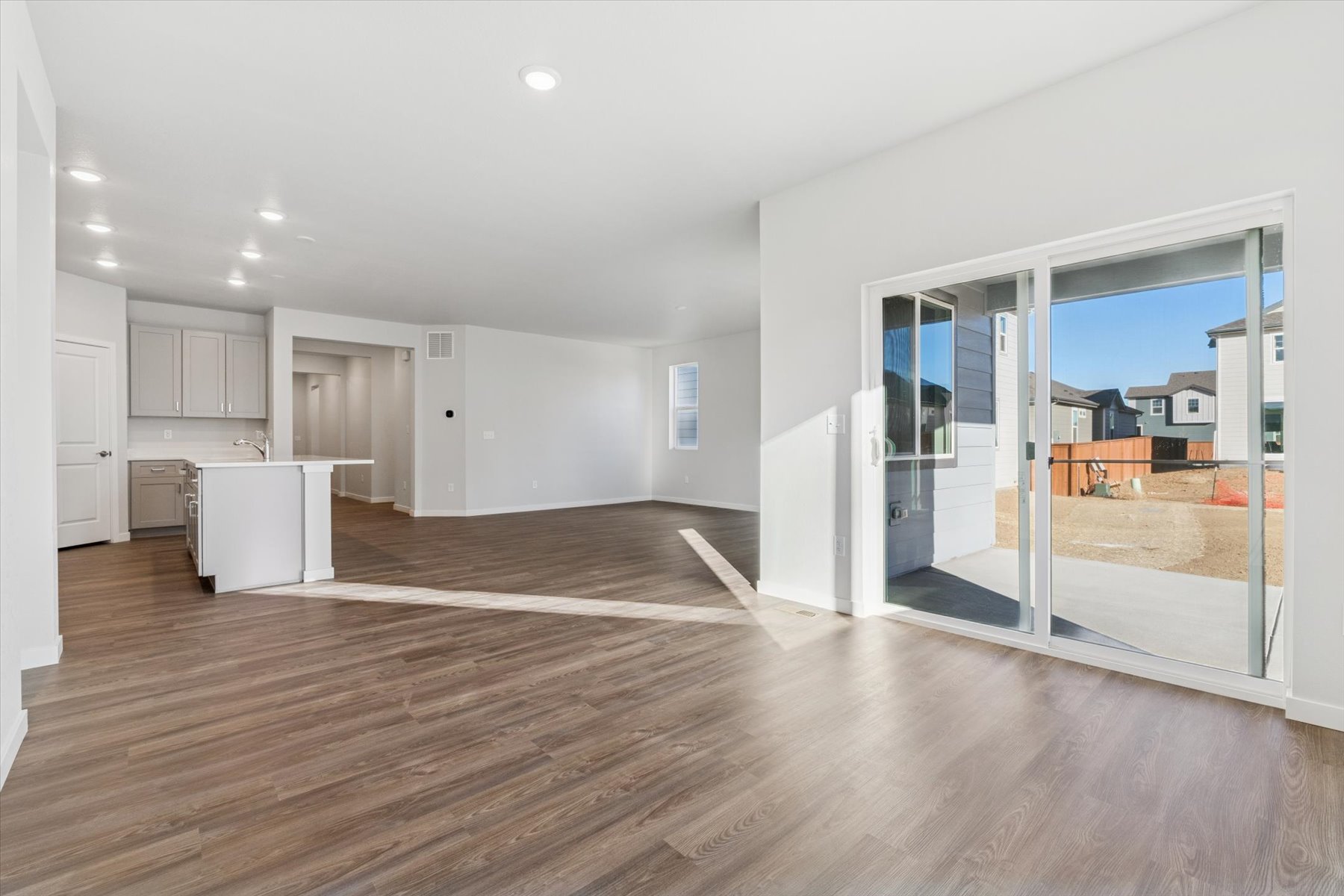 A large empty room with a glass door.