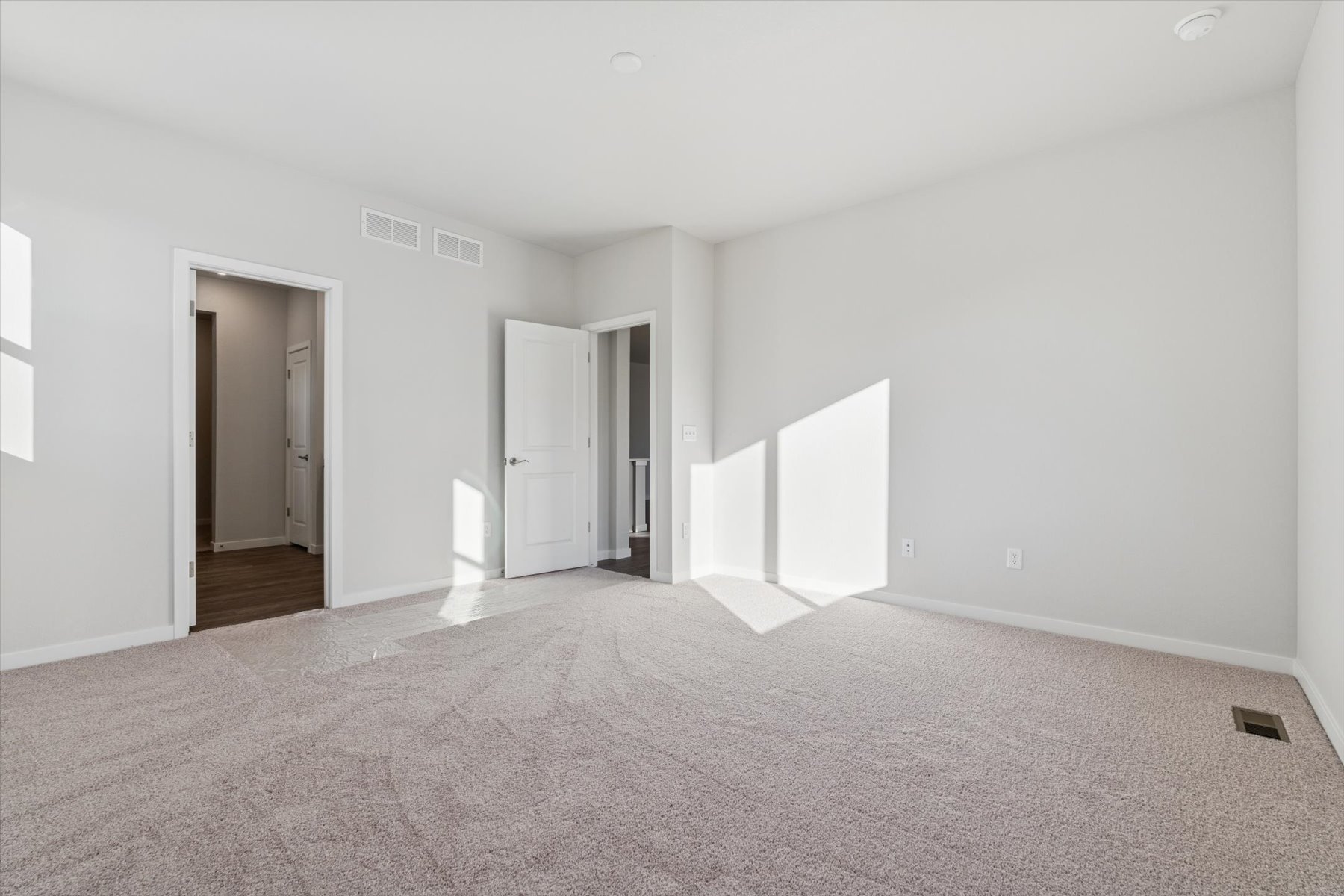 A long hallway with white walls.