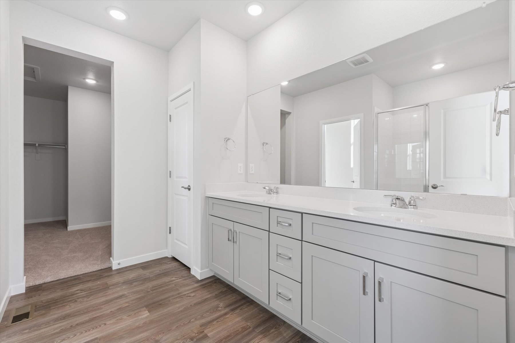 A bathroom with white cabinets.