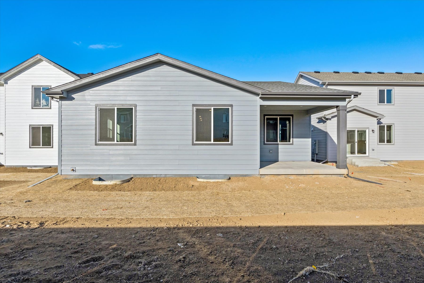 A house with a dirt yard.