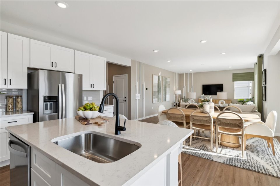A kitchen with white cabinets.