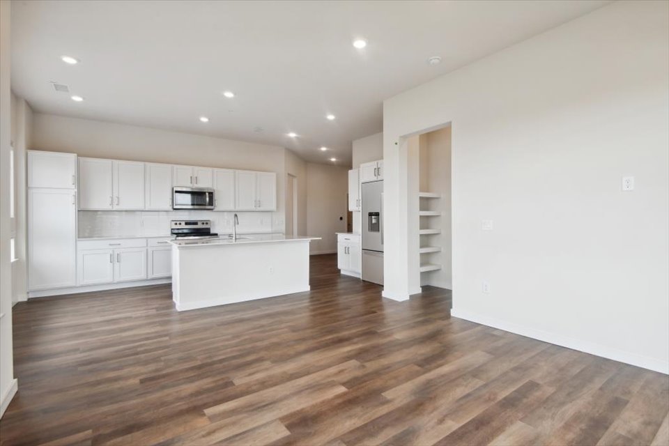 A kitchen with white cabinets.
