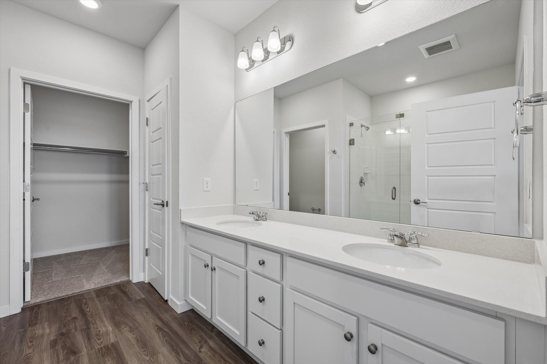 A bathroom with a large mirror.