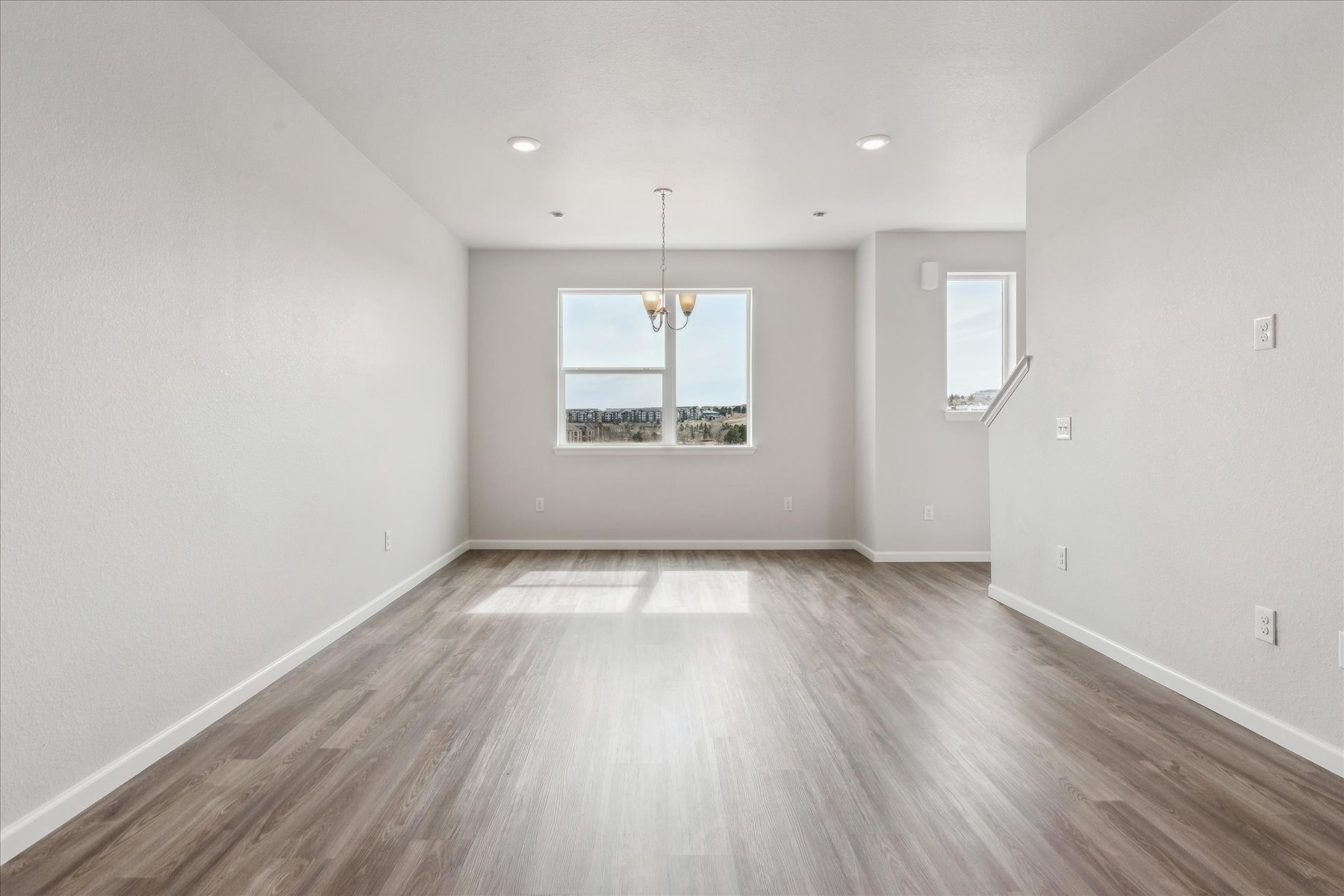 A room with a wood floor and a window.
