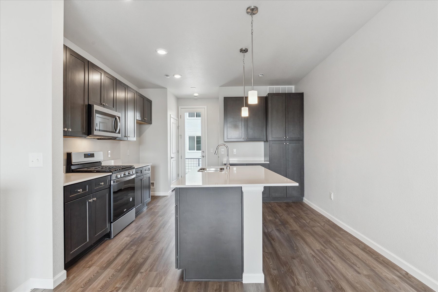 A kitchen with black cabinets.