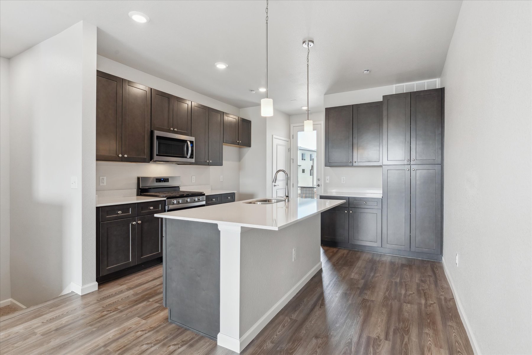 A kitchen with black cabinets.