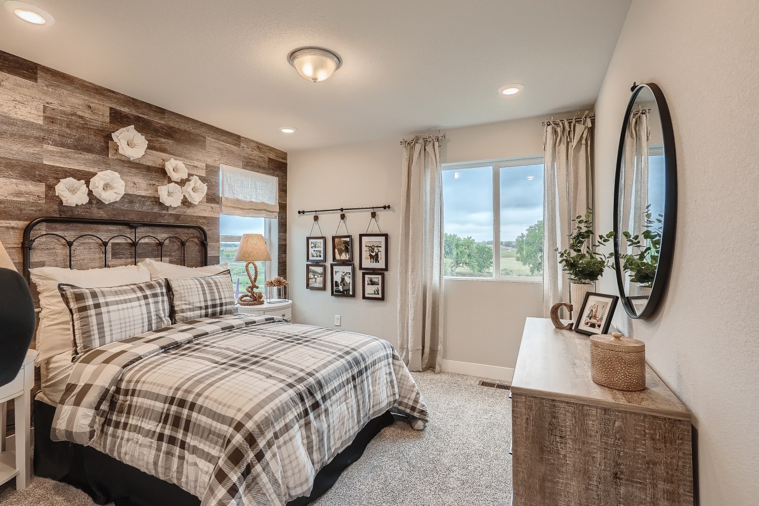 A bedroom with a bed and a mirror.