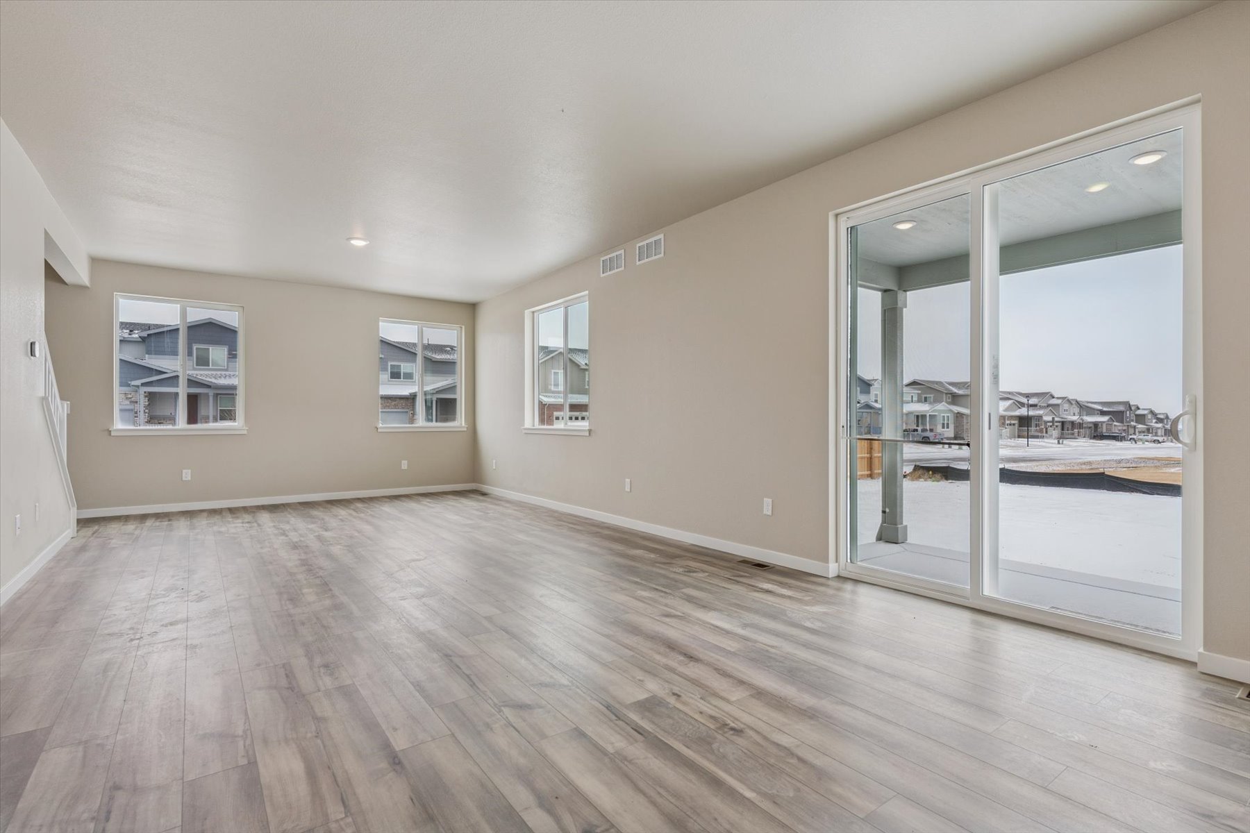 A room with a wood floor and a glass door.