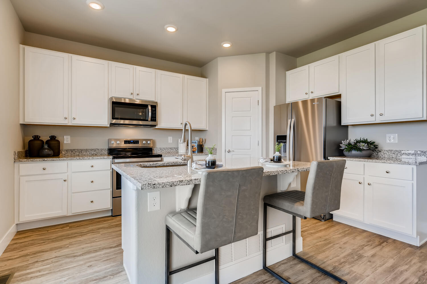 A kitchen with white cabinets.