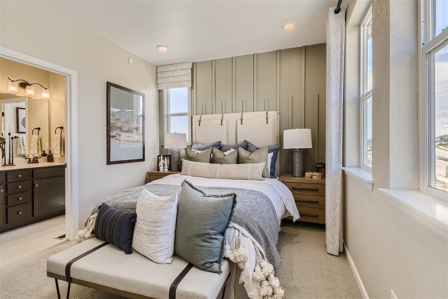 A bedroom with a bed and a chair.