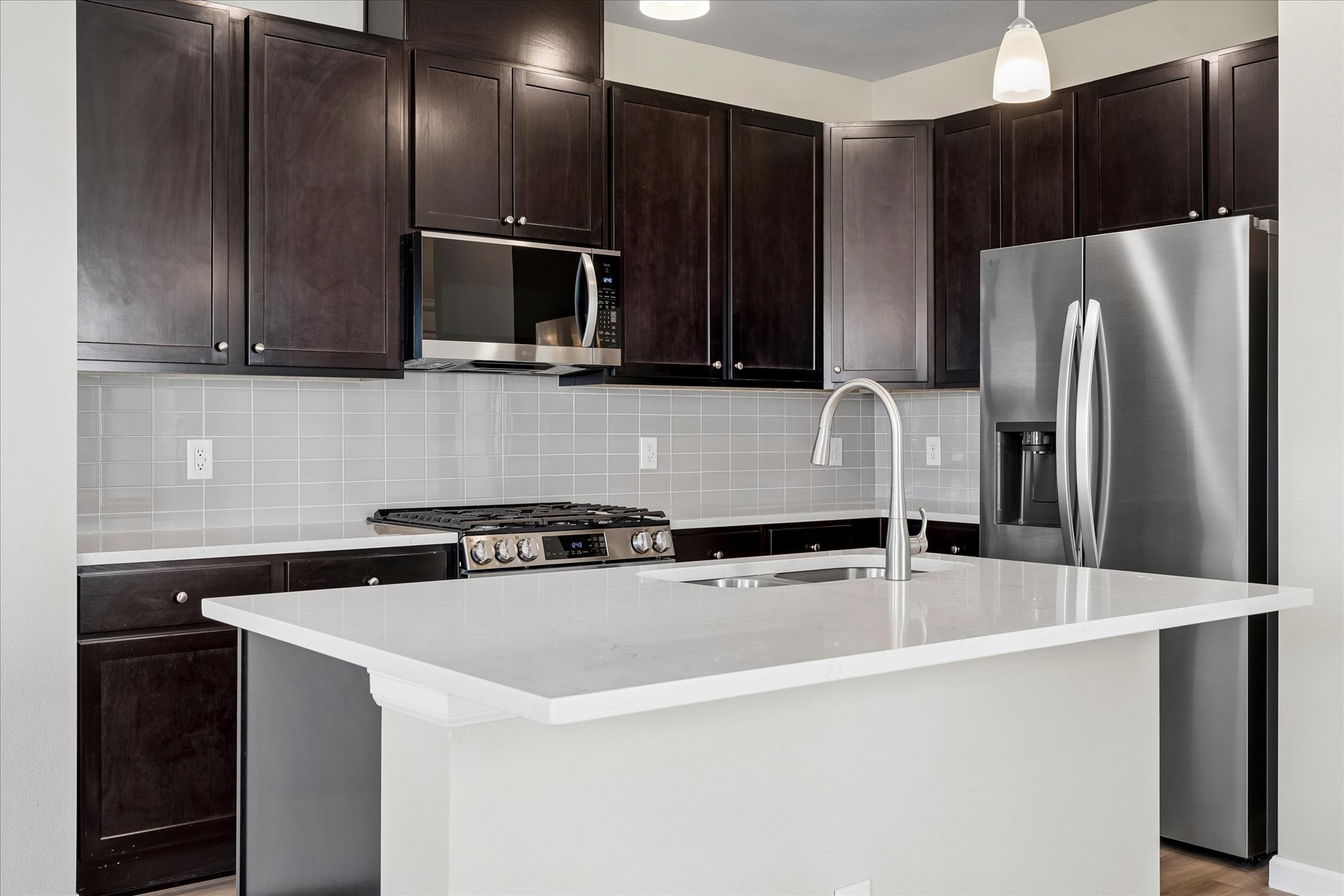A kitchen with black cabinets.