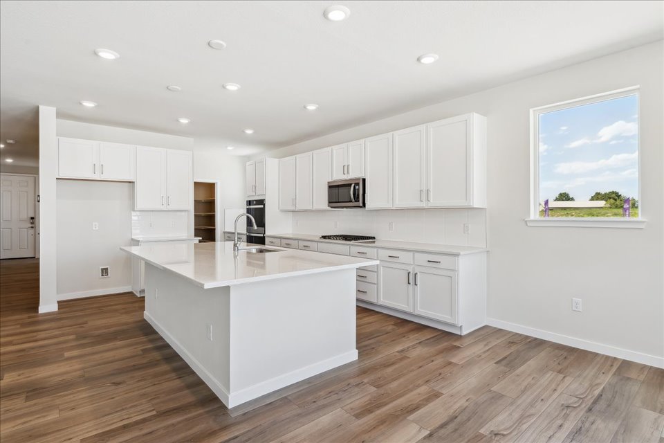 A kitchen with white cabinets.